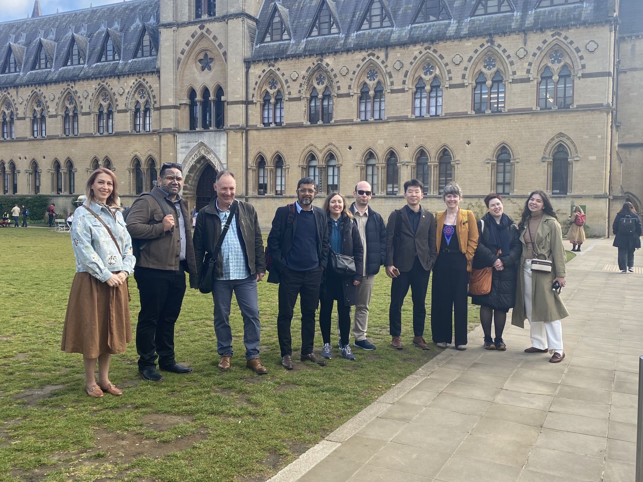 Ten conference delegates standing outside the Oxford Natural History Museum.